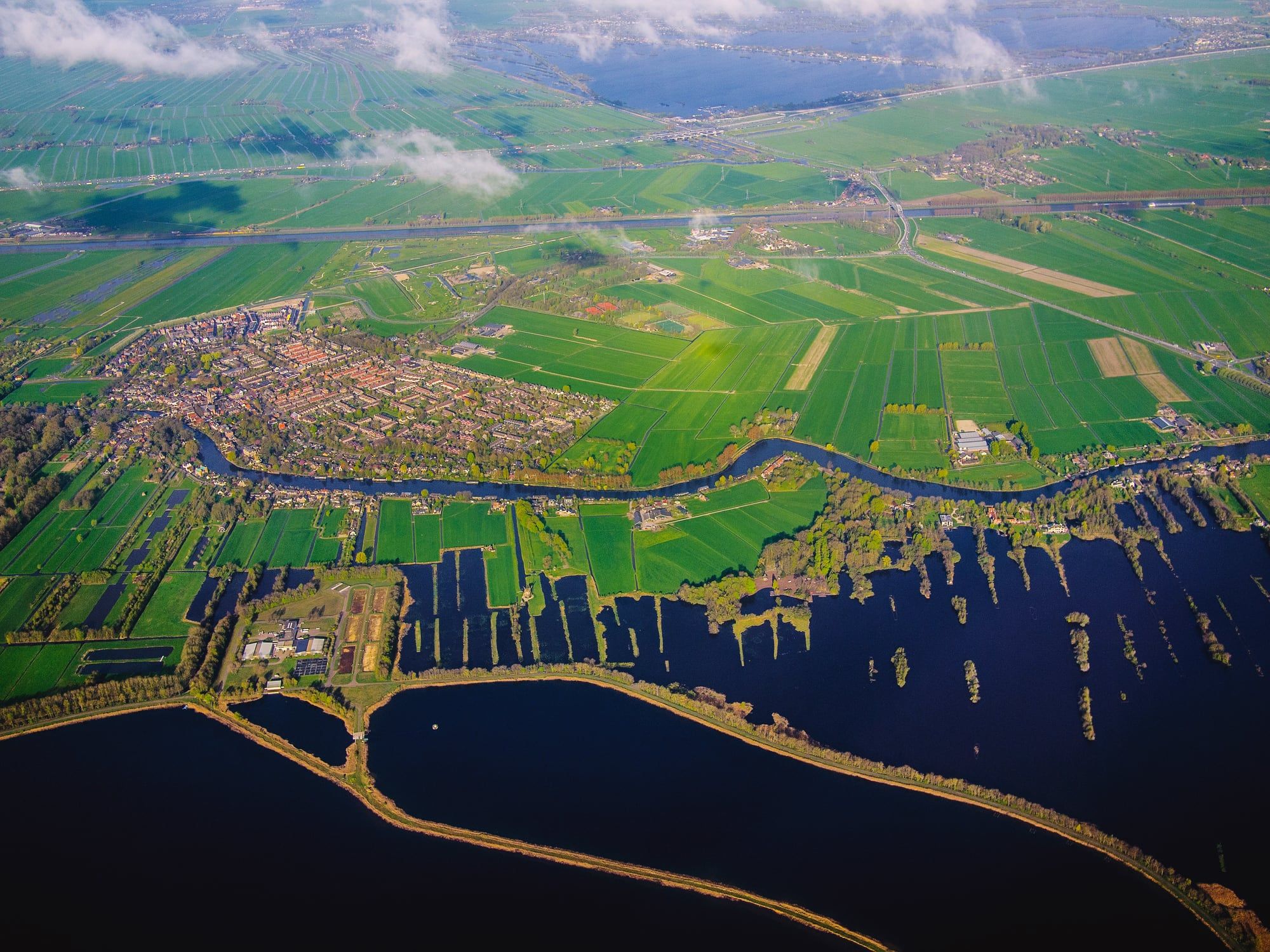 Aerial view of the Dutch landscape of fields, tree lines and water around Almelo